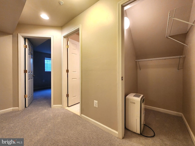 corridor with light colored carpet and baseboards