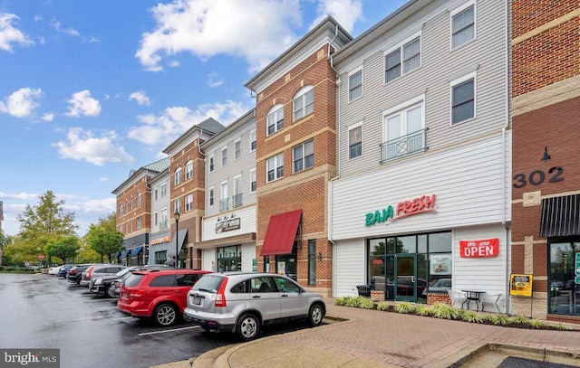 view of building exterior with uncovered parking