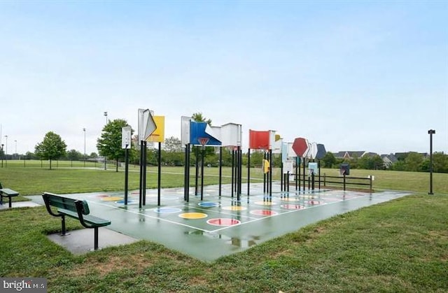 view of community with a yard and community basketball court