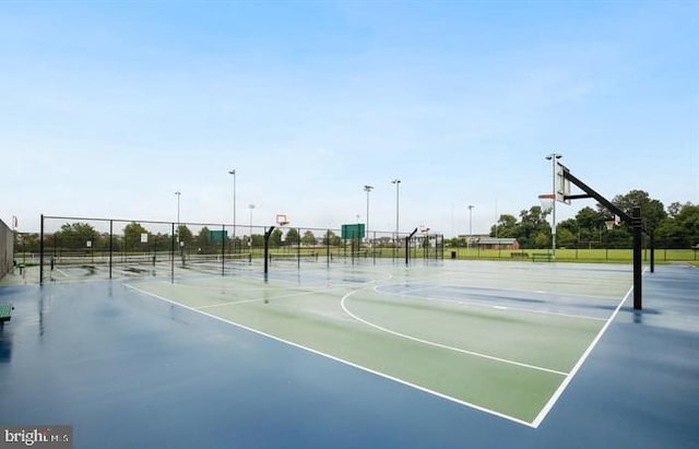 view of basketball court with community basketball court and fence