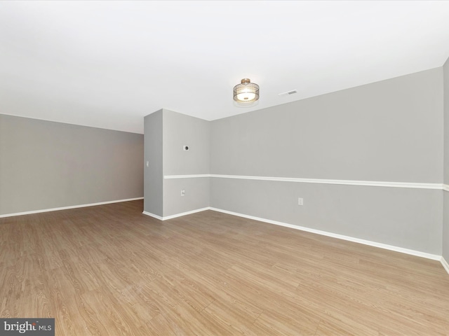 interior space featuring light wood-style flooring, visible vents, and baseboards