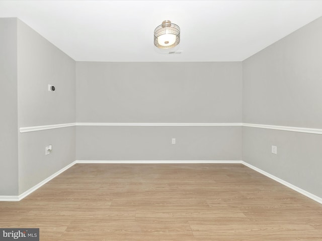 empty room featuring light wood-style flooring and baseboards