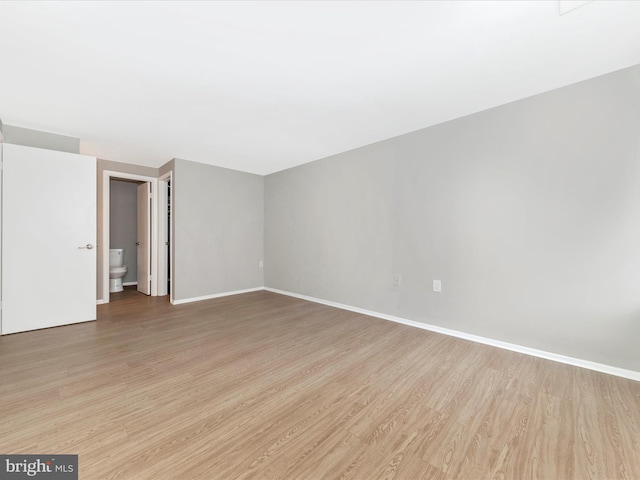 unfurnished room with light wood-style floors and baseboards