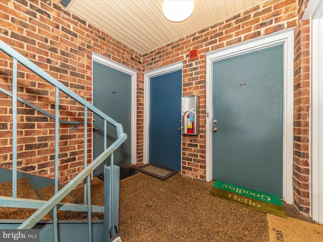 property entrance with brick siding