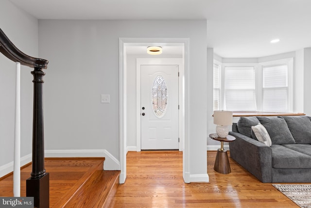 foyer entrance featuring stairway, recessed lighting, light wood-style flooring, and baseboards