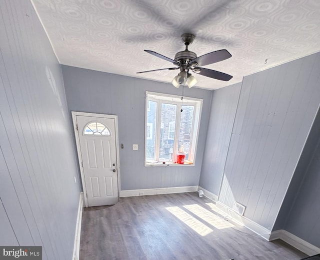 entryway with a ceiling fan, baseboards, and wood finished floors