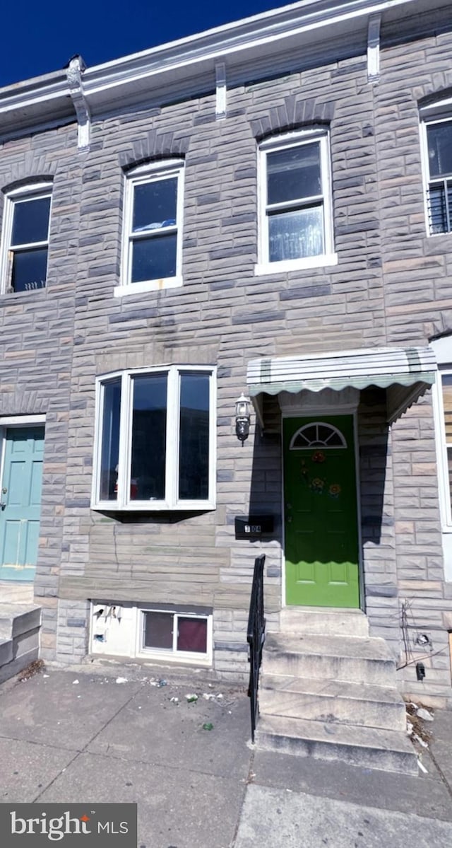 entrance to property featuring stone siding