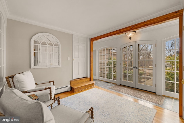 living area featuring ornamental molding, a baseboard heating unit, french doors, and wood finished floors