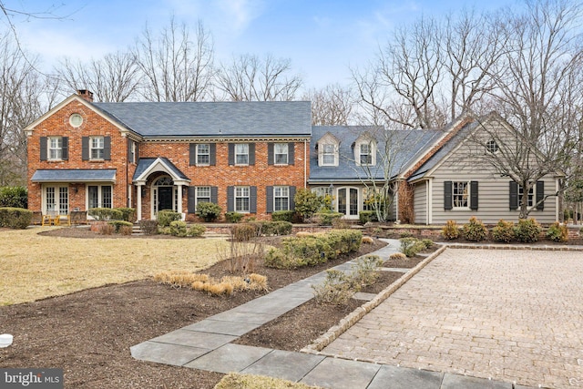 view of front of property featuring french doors and brick siding