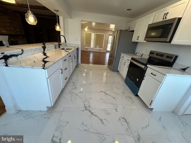 kitchen with marble finish floor, stainless steel appliances, light countertops, white cabinetry, and a sink