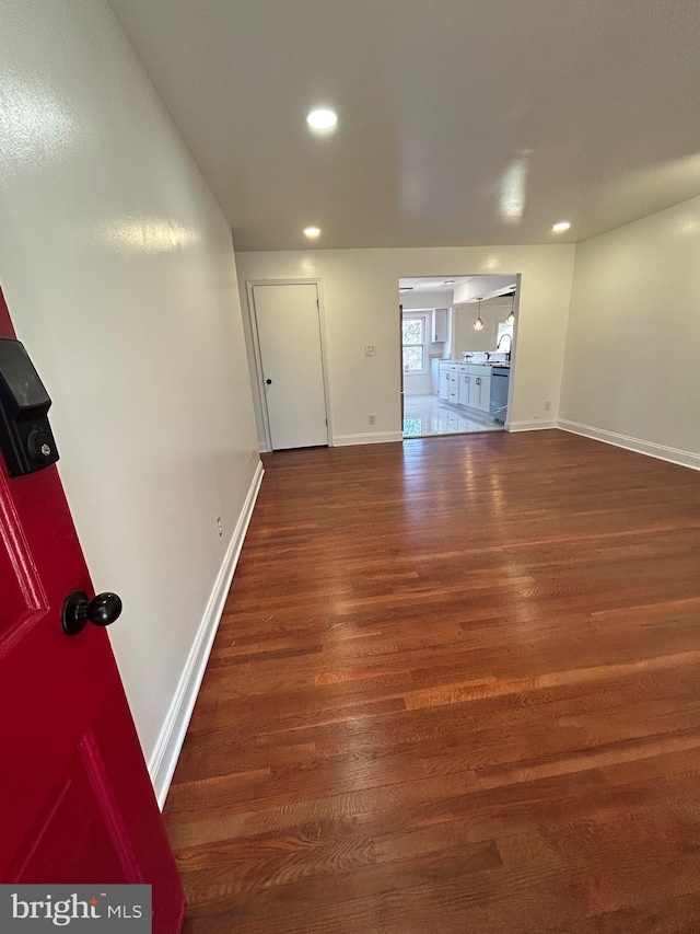 spare room with recessed lighting, wood finished floors, and baseboards