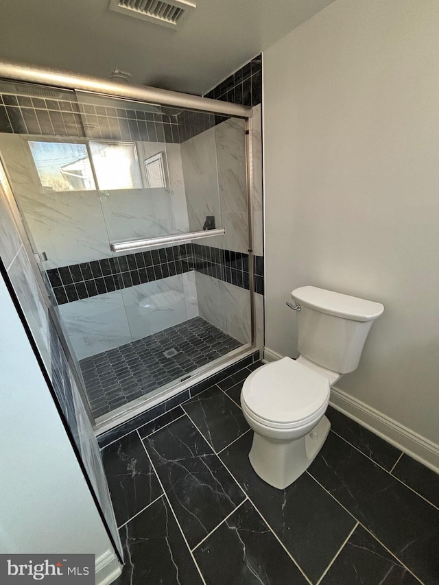 full bathroom featuring marble finish floor, visible vents, toilet, a stall shower, and baseboards