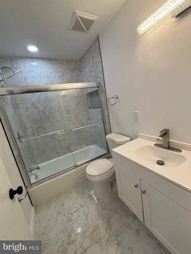 bathroom with toilet, shower / bath combination with glass door, vanity, visible vents, and marble finish floor