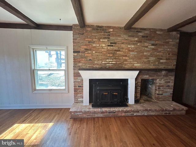 interior space with beam ceiling and wood finished floors