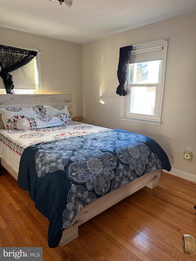 bedroom with wood finished floors and baseboards