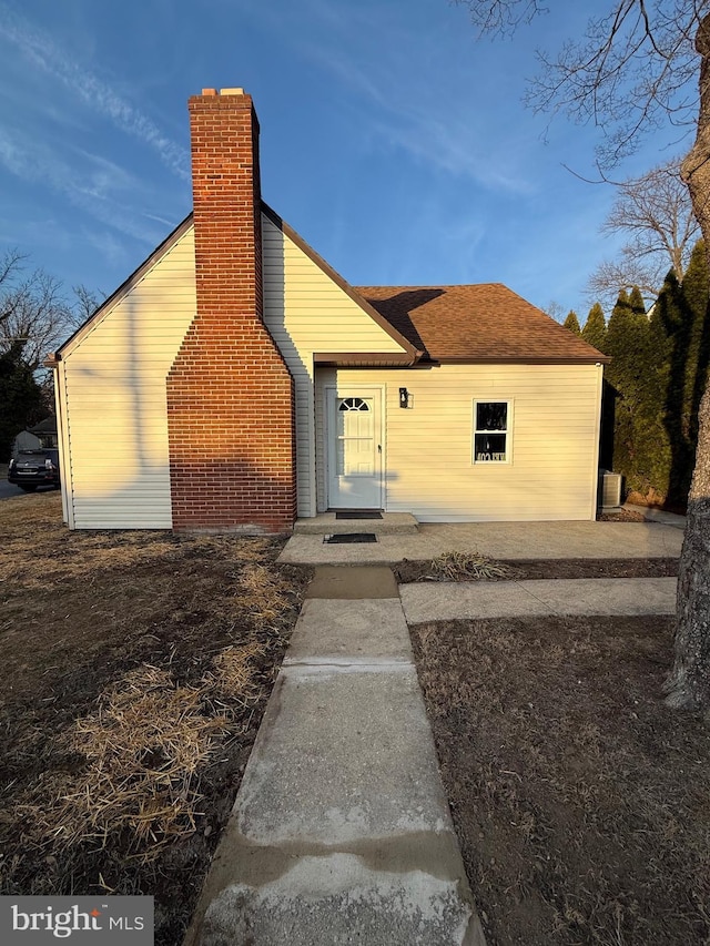 view of front of home featuring a chimney