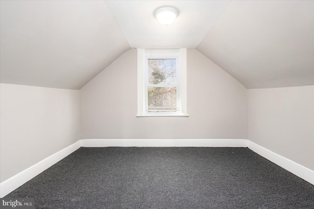 bonus room featuring carpet flooring, vaulted ceiling, and baseboards