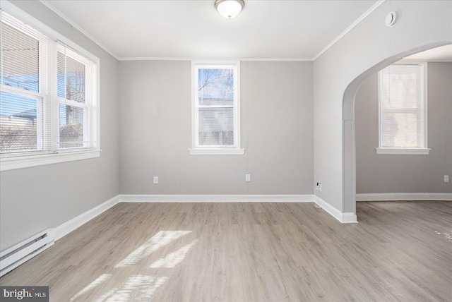 unfurnished room featuring arched walkways, light wood finished floors, baseboard heating, and crown molding