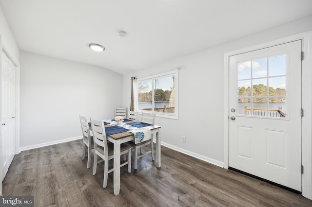 dining area featuring dark wood-style floors and baseboards