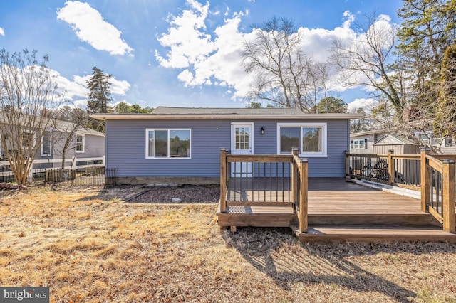 view of front of house with fence and a wooden deck