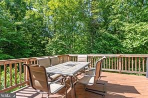 wooden deck featuring outdoor dining space