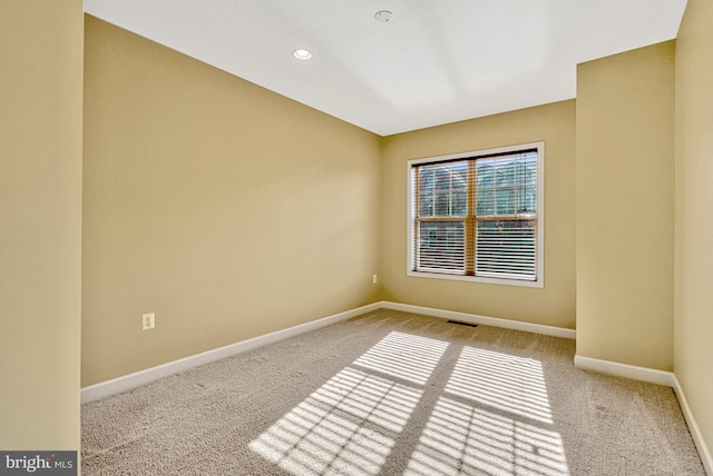 carpeted spare room with recessed lighting, visible vents, and baseboards