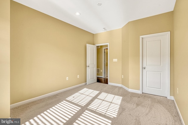 unfurnished bedroom featuring visible vents, recessed lighting, light colored carpet, and baseboards