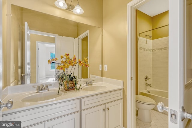 bathroom with double vanity, bathing tub / shower combination, a sink, and toilet