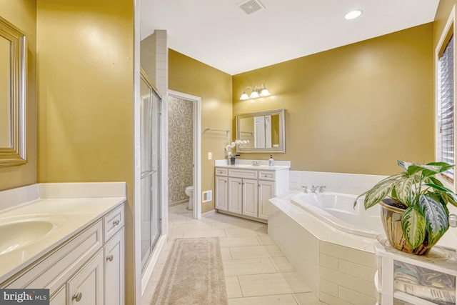 full bath with a stall shower, visible vents, two vanities, a garden tub, and a sink