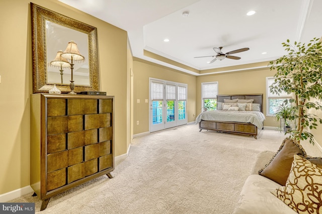 bedroom with carpet flooring, baseboards, access to exterior, ornamental molding, and a raised ceiling