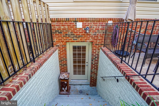 view of exterior entry with brick siding