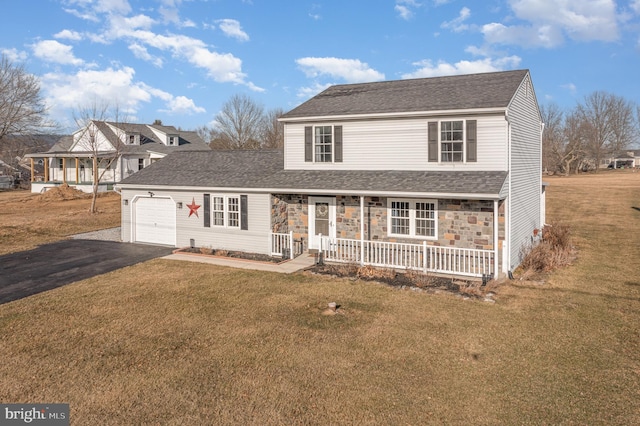 traditional home with driveway, stone siding, a porch, an attached garage, and a front lawn