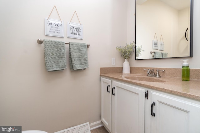 bathroom with baseboards, visible vents, and vanity