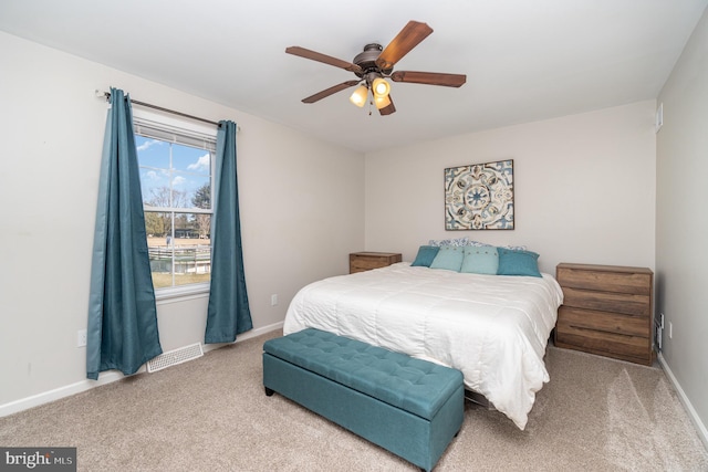 carpeted bedroom featuring visible vents, ceiling fan, and baseboards