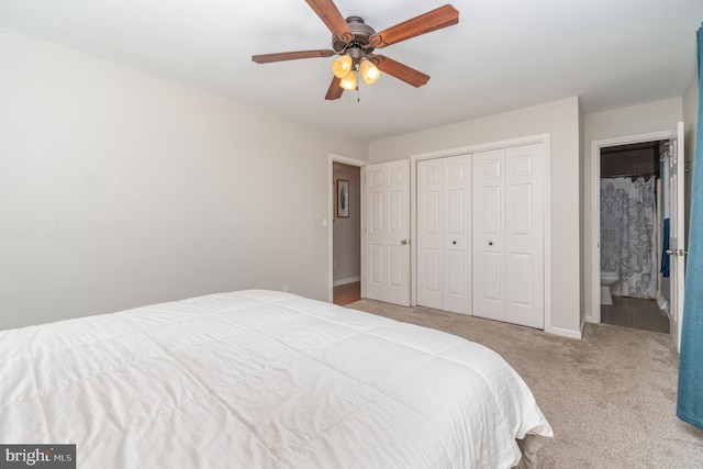 carpeted bedroom with a closet, ceiling fan, and baseboards