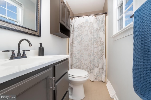 bathroom featuring toilet, a shower with curtain, and vanity