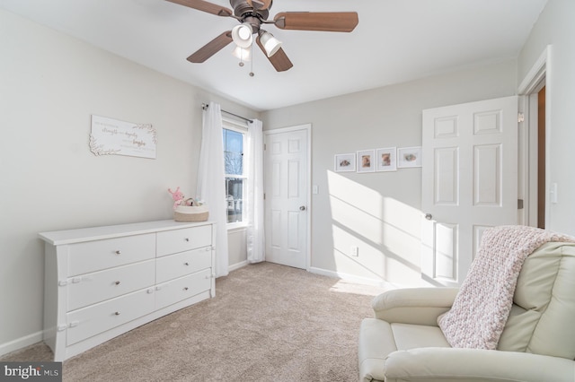 bedroom with a ceiling fan, light carpet, and baseboards