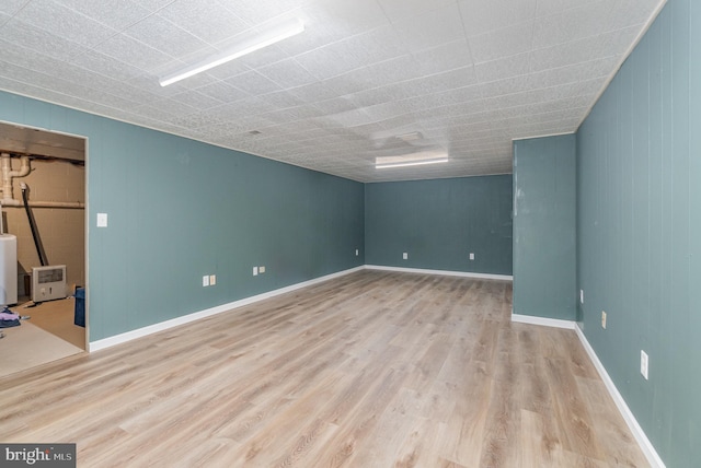 spare room with wood finished floors and baseboards