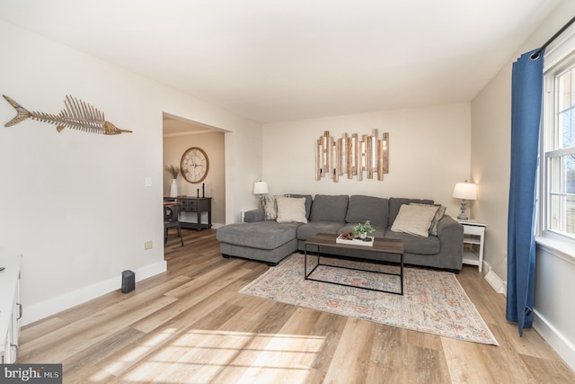 living room featuring wood finished floors and baseboards