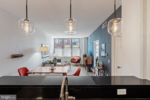 dining area featuring wood finished floors and visible vents