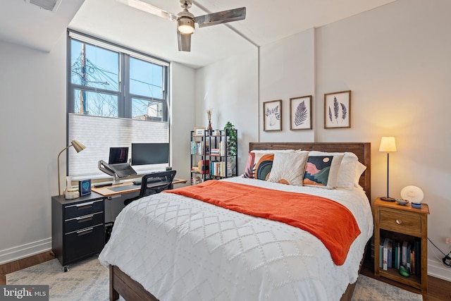 bedroom with visible vents, baseboards, ceiling fan, and wood finished floors