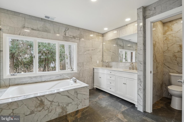 full bath featuring toilet, double vanity, visible vents, and a sink