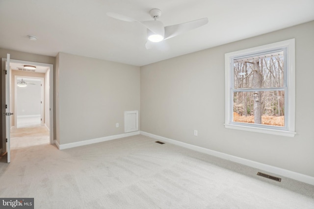 unfurnished bedroom with light carpet, baseboards, visible vents, and a ceiling fan