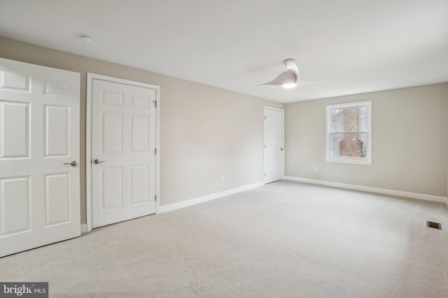 unfurnished bedroom with visible vents, baseboards, and carpet flooring