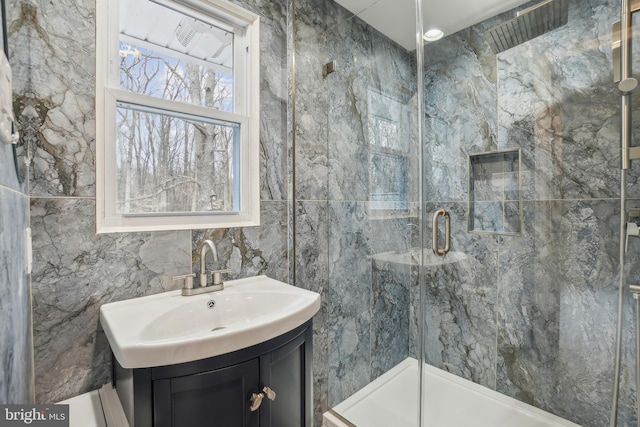 bathroom featuring a shower stall and vanity