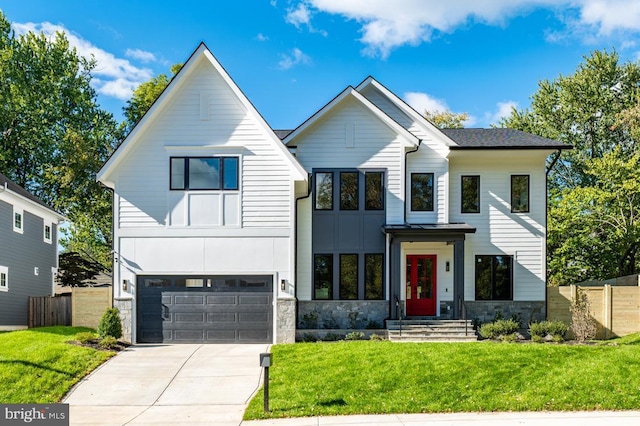 modern farmhouse style home featuring driveway, a garage, stone siding, fence, and a front yard