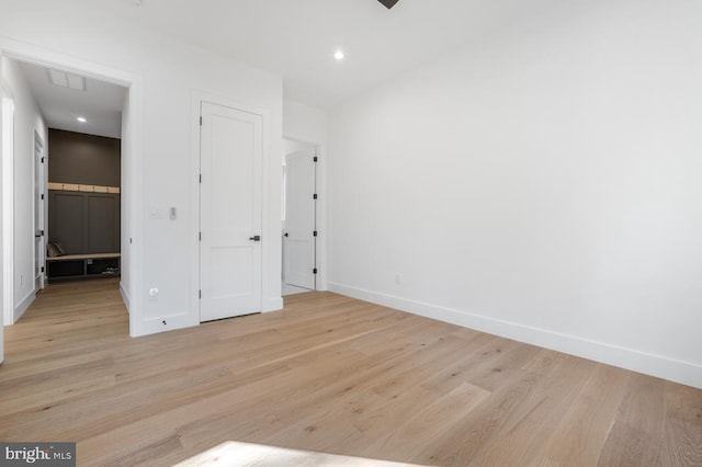 unfurnished bedroom featuring baseboards, recessed lighting, visible vents, and light wood-style floors