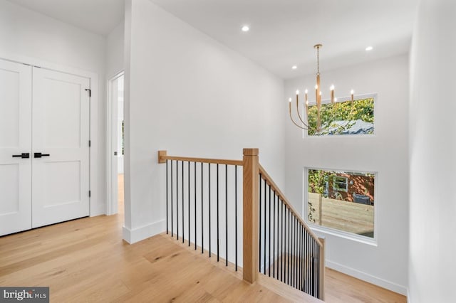 hallway featuring plenty of natural light, wood finished floors, and recessed lighting