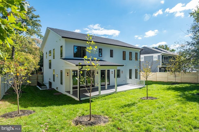 back of property featuring a fenced backyard, a patio, and a yard