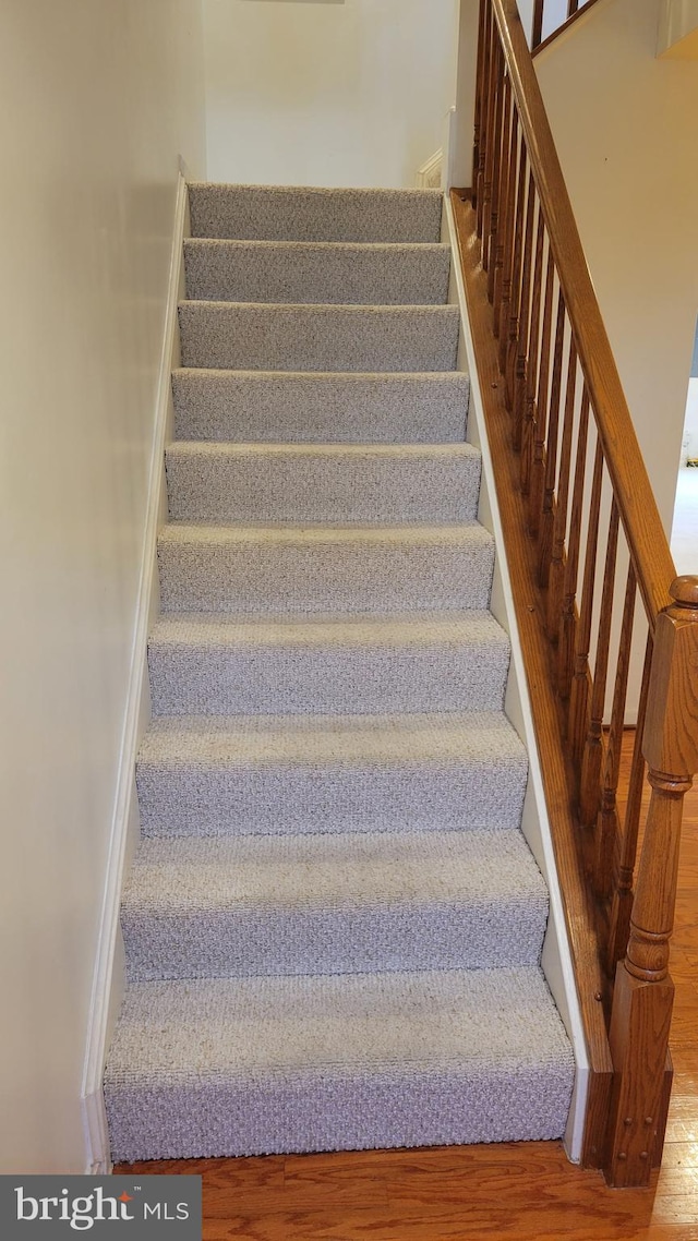 stairway with wood finished floors